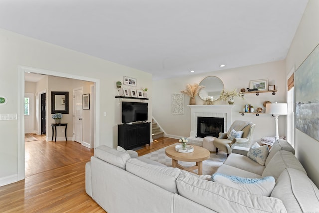 11 Quarry Ridge Rd, Newtown, CT 06482 - living area with light wood-style floors, a brick fireplace, recessed lighting, and stairway
