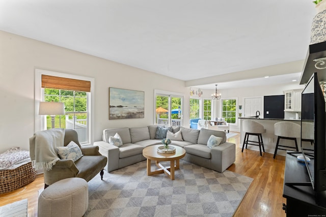 11 Quarry Ridge Rd, Newtown, CT 06482 - living room featuring a chandelier and light wood-style flooring