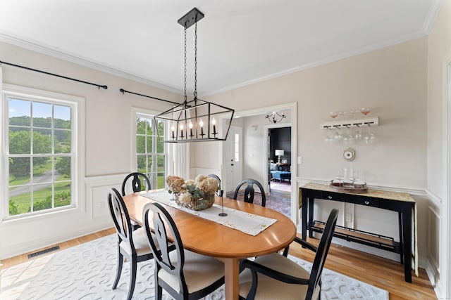 11 Quarry Ridge Rd, Newtown, CT 06482 - dining room with light wood finished floors, crown molding, a wainscoted wall, and a chandelier