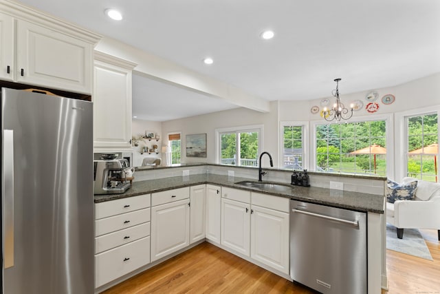 11 Quarry Ridge Rd, Newtown, CT 06482 - kitchen with appliances with stainless steel finishes, light wood-style floors, dark stone counters, recessed lighting, and white cabinets
