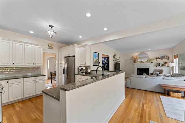 11 Quarry Ridge Rd, Newtown, CT 06482 - kitchen featuring stainless steel fridge, dark stone countertops, light wood-type flooring, white cabinetry, and recessed lighting