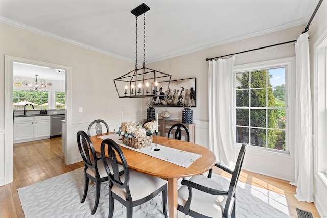 11 Quarry Ridge Rd, Newtown, CT 06482 - dining area with a chandelier, crown molding, light wood-type flooring, and a wainscoted wall