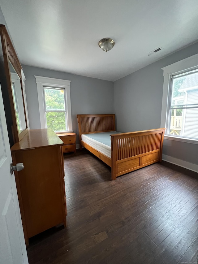 87 Blake St, New Haven, CT 06511 - unfurnished bedroom featuring multiple windows and dark wood-style flooring
