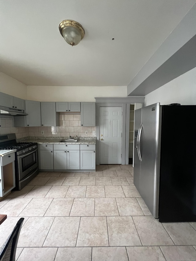 87 Blake St, New Haven, CT 06511 - kitchen featuring stainless steel appliances, gray cabinets, under cabinet range hood, decorative backsplash, and light tile patterned flooring