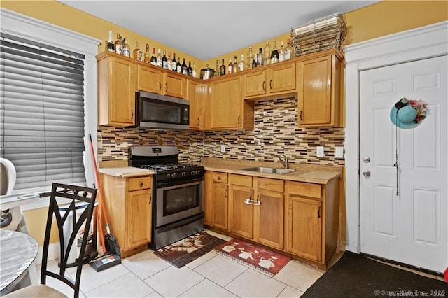 87 Blake St, New Haven, CT 06511 - kitchen with appliances with stainless steel finishes, light countertops, light tile patterned floors, and decorative backsplash