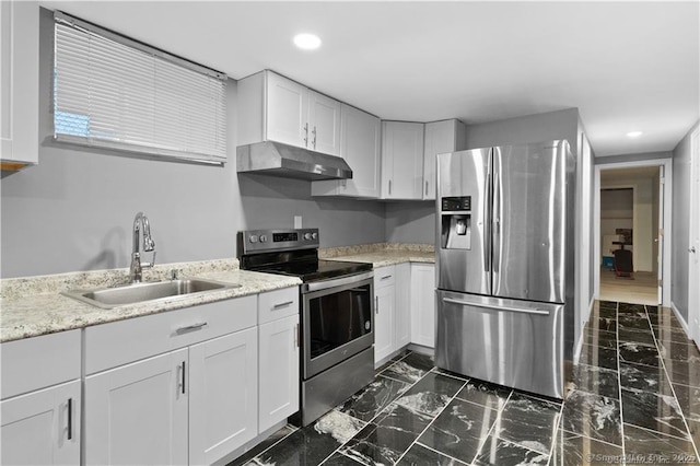 87 Blake St, New Haven, CT 06511 - kitchen with appliances with stainless steel finishes, under cabinet range hood, white cabinets, dark marble finish floors, and recessed lighting