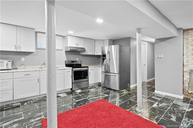 87 Blake St, New Haven, CT 06511 - kitchen with stainless steel appliances, under cabinet range hood, dark marble finish floors, recessed lighting, and white cabinets