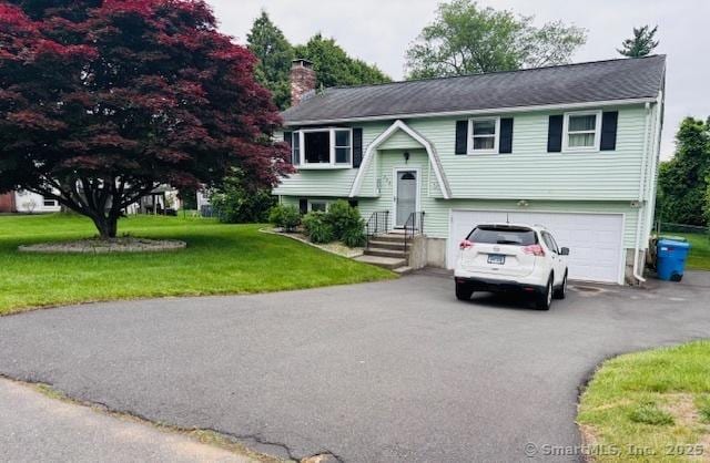 272 Westwoods Ter, Bristol, CT 06010 - bi-level home with a chimney, driveway, an attached garage, and a front lawn