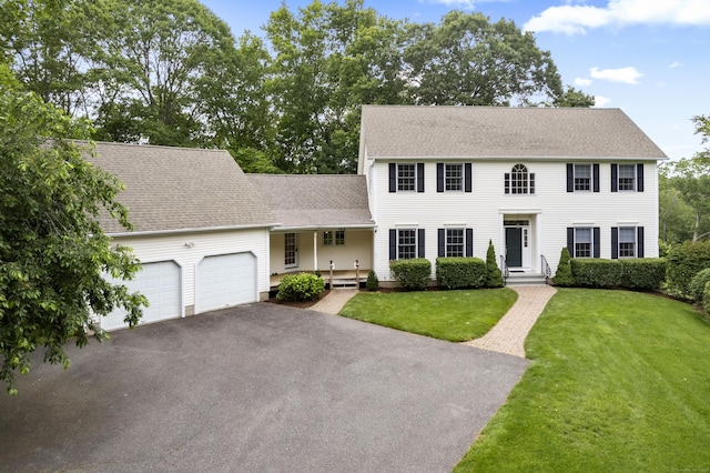 102 Leetes Island Rd, Guilford, CT 06437 - colonial house with an attached garage, a front lawn, asphalt driveway, and roof with shingles