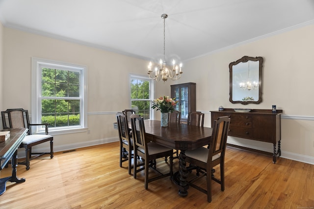 102 Leetes Island Rd, Guilford, CT 06437 - dining area with a chandelier, light wood-style floors, ornamental molding, and baseboards