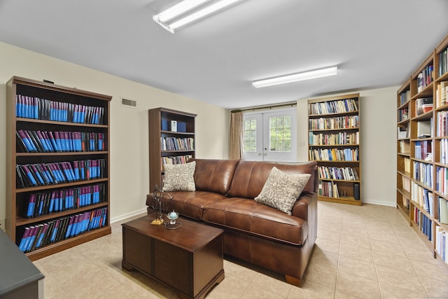 102 Leetes Island Rd, Guilford, CT 06437 - living area featuring bookshelves and tile patterned floors
