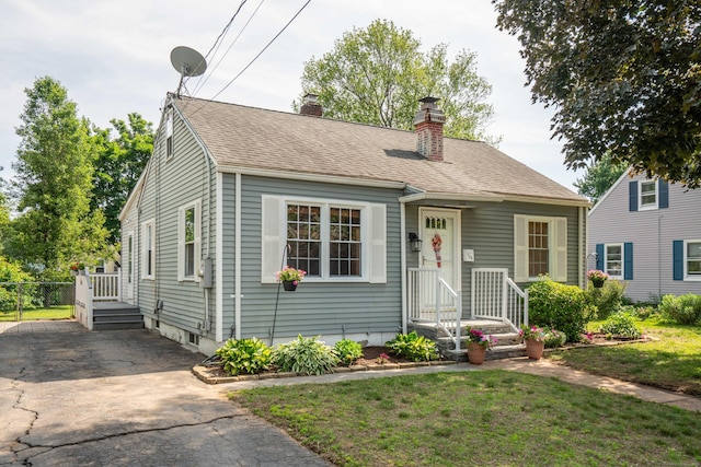 159 Cambridge Dr, East Hartford, CT 06118 - view of front of house featuring a chimney and a shingled roof