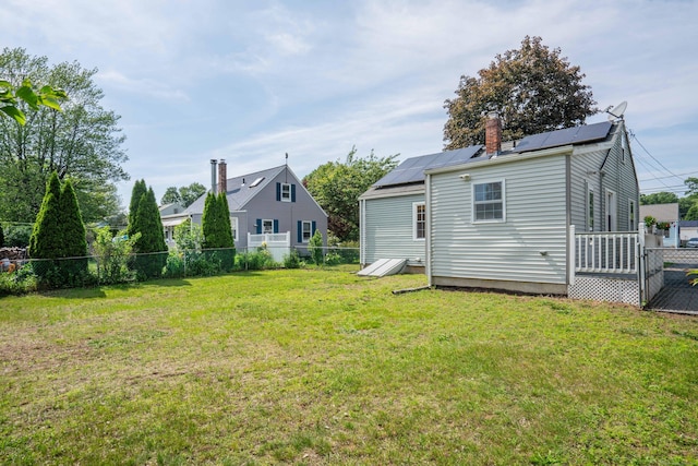 159 Cambridge Dr, East Hartford, CT 06118 - rear view of house featuring a chimney and roof mounted solar panels