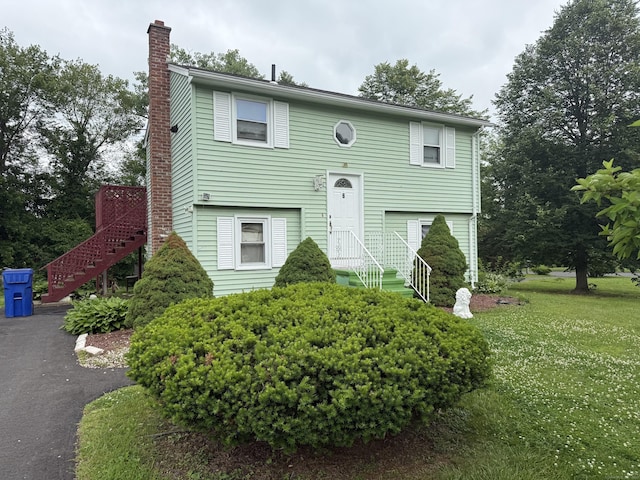6 Sandra Dr, Bloomfield, CT 06002 - split foyer home featuring a chimney, a front yard, stairway, and asphalt driveway
