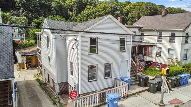 220 Franklin St, Norwich, CT 06360 - view of front facade featuring a patio, stairway, and a shingled roof