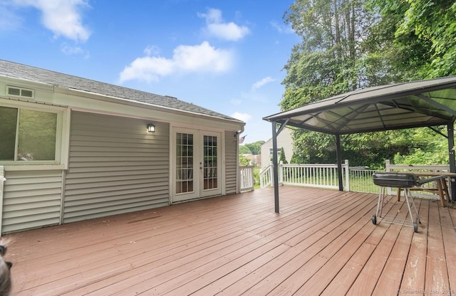 wooden deck with a gazebo and french doors