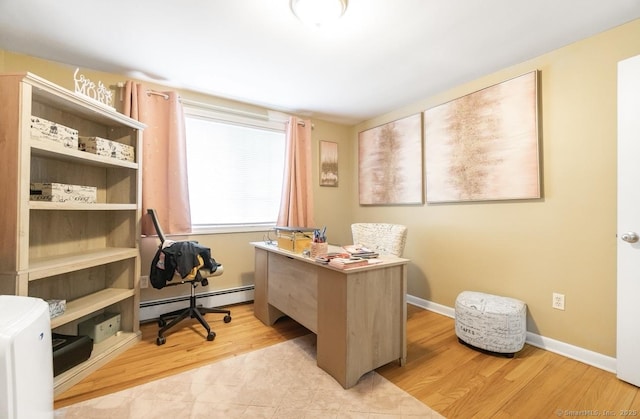 home office featuring baseboard heating and light wood-style flooring