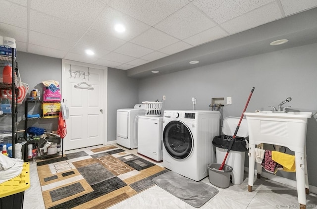 laundry area with independent washer and dryer and recessed lighting