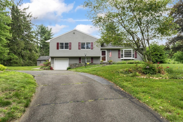 128 Walnut Tree Hill Rd, Newtown, CT 06482 - split level home with asphalt driveway, a front lawn, and an attached garage