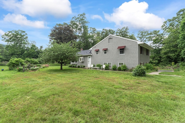 128 Walnut Tree Hill Rd, Newtown, CT 06482 - view of property exterior featuring a lawn and a chimney