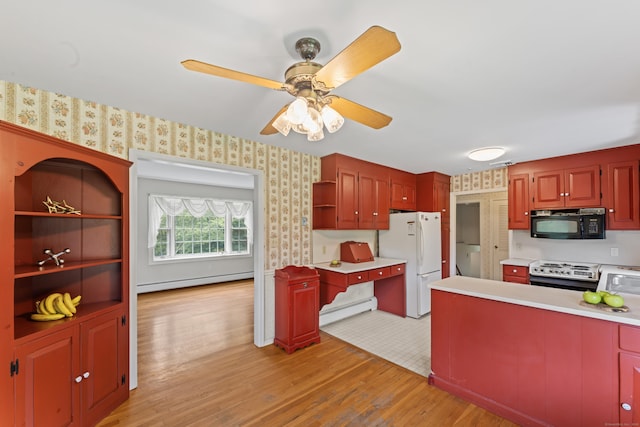 128 Walnut Tree Hill Rd, Newtown, CT 06482 - kitchen with black microwave, stainless steel range oven, wallpapered walls, freestanding refrigerator, and a baseboard radiator