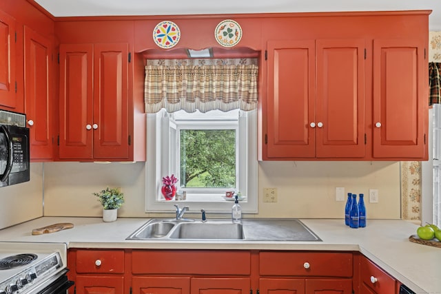 128 Walnut Tree Hill Rd, Newtown, CT 06482 - kitchen with black microwave, light countertops, and range with electric cooktop