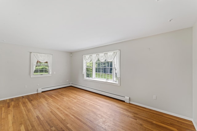 128 Walnut Tree Hill Rd, Newtown, CT 06482 - empty room with plenty of natural light, wood finished floors, a baseboard heating unit, and a baseboard radiator