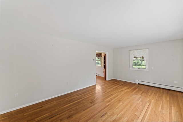 128 Walnut Tree Hill Rd, Newtown, CT 06482 - unfurnished room with a baseboard heating unit, light wood-style floors, and baseboard heating