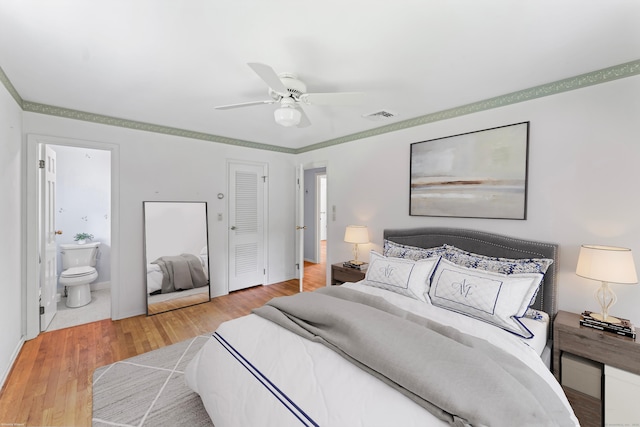 128 Walnut Tree Hill Rd, Newtown, CT 06482 - bedroom with light wood-style flooring, ensuite bath, and a ceiling fan