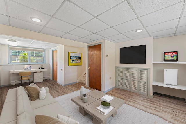 128 Walnut Tree Hill Rd, Newtown, CT 06482 - living room featuring a paneled ceiling, wood finished floors, stairway, a desk, and baseboard heating