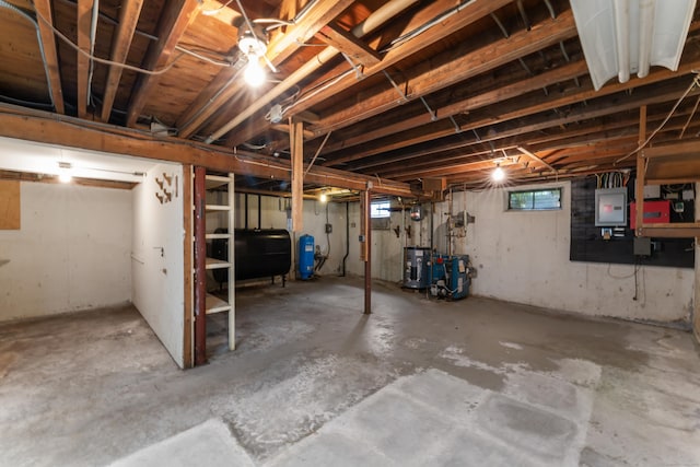 128 Walnut Tree Hill Rd, Newtown, CT 06482 - below grade area with oil tank, electric panel, water heater, a water pressure tank, and a heating unit