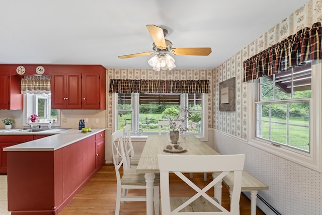 128 Walnut Tree Hill Rd, Newtown, CT 06482 - kitchen featuring wallpapered walls, light countertops, light wood-style floors, ceiling fan, and a peninsula