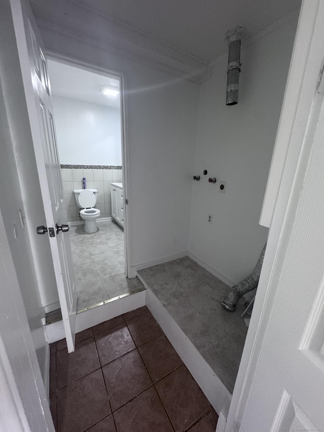 61 Naubuc Ave, East Hartford, CT 06118 - bathroom with tile patterned floors, toilet, and tile walls