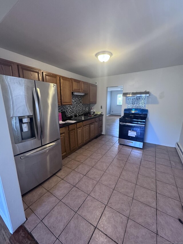 61 Naubuc Ave, East Hartford, CT 06118 - kitchen featuring stainless steel refrigerator with ice dispenser, range with gas cooktop, dark countertops, light tile patterned floors, and tasteful backsplash