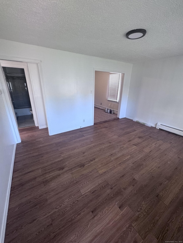 61 Naubuc Ave, East Hartford, CT 06118 - spare room with dark wood-type flooring, a textured ceiling, baseboard heating, and baseboards