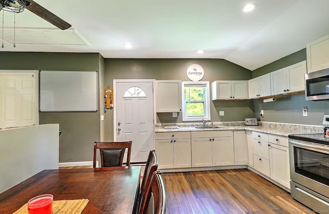 63 Bailey St, Brooklyn, CT 06234 - kitchen featuring appliances with stainless steel finishes, wood finished floors, white cabinets, lofted ceiling, and recessed lighting