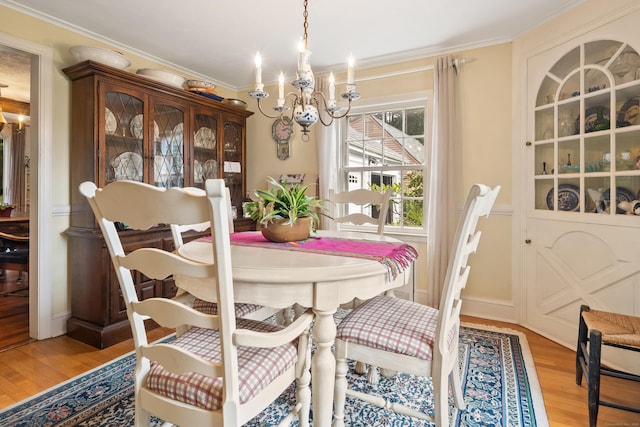 46 Dyer Ave, Canton, CT 06019 - dining space featuring a chandelier, light wood-style flooring, and crown molding