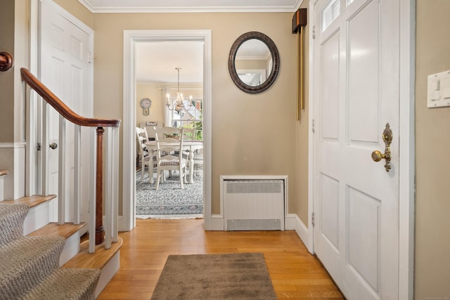 46 Dyer Ave, Canton, CT 06019 - entrance foyer with light wood-type flooring, crown molding, radiator, and a chandelier