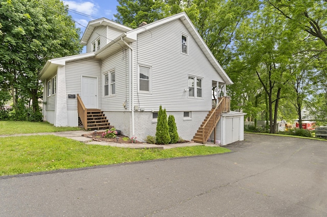 471 New Britain Rd, Berlin, CT 06037 - view of side of home featuring stairway, a lawn, and a garage