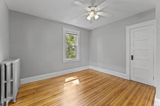 471 New Britain Rd, Berlin, CT 06037 - spare room featuring radiator heating unit, light wood-style floors, and a ceiling fan