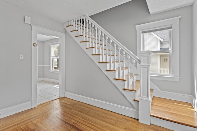 471 New Britain Rd, Berlin, CT 06037 - stairway with hardwood / wood-style floors and a textured ceiling