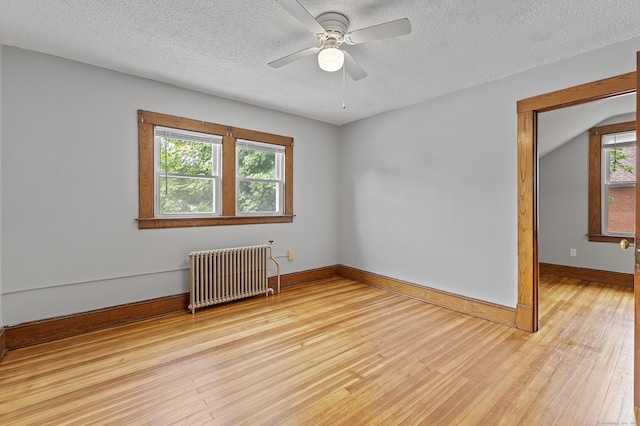 471 New Britain Rd, Berlin, CT 06037 - empty room featuring radiator heating unit, light wood-type flooring, ceiling fan, and a textured ceiling