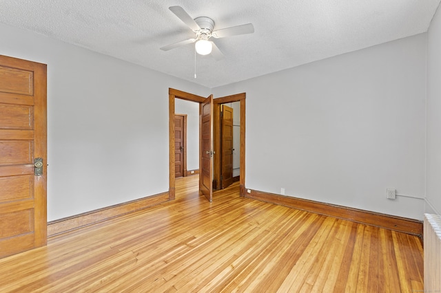 471 New Britain Rd, Berlin, CT 06037 - unfurnished room with radiator heating unit, ceiling fan, light wood-style flooring, a textured ceiling, and baseboard heating