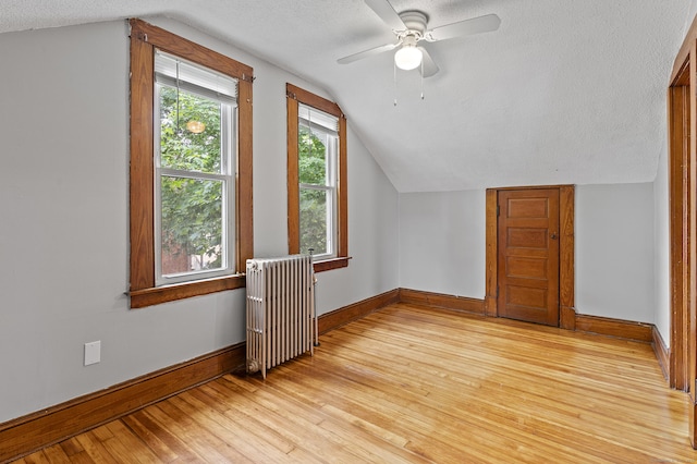 471 New Britain Rd, Berlin, CT 06037 - additional living space featuring radiator heating unit, vaulted ceiling, a textured ceiling, light wood-style floors, and a ceiling fan