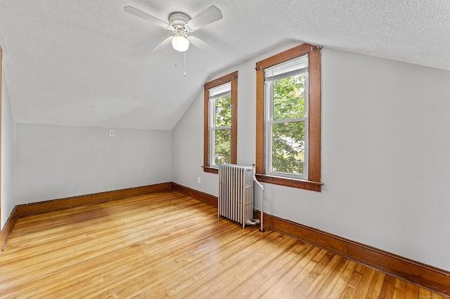 471 New Britain Rd, Berlin, CT 06037 - bonus room featuring radiator heating unit, a textured ceiling, light wood-style flooring, lofted ceiling, and a ceiling fan