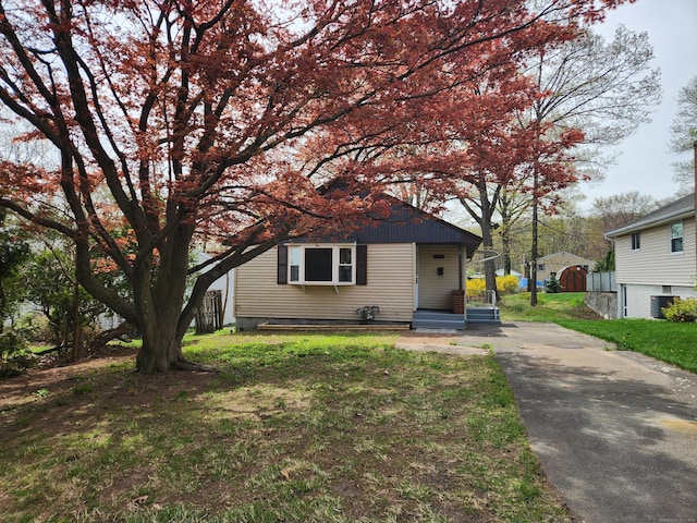84 May St, New Britain, CT 06052 - view of front of home with central AC unit, driveway, and a front yard