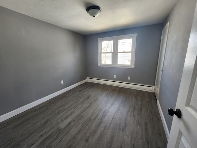 84 May St, New Britain, CT 06052 - spare room with a baseboard heating unit, dark wood finished floors, and baseboards