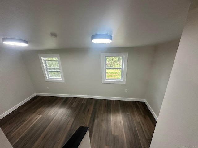22 Hemlock Trl, Newtown, CT 06482 - empty room with healthy amount of natural light, baseboards, and dark wood-style flooring