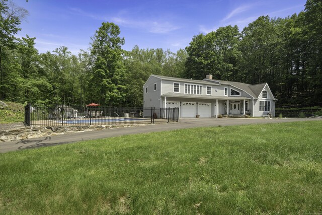 1729 Litchfield Rd, Watertown, CT 06795 - rear view of house with a garage, a chimney, and asphalt driveway