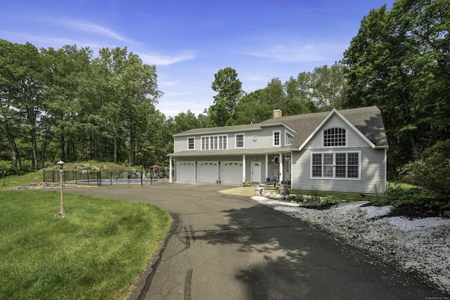 1729 Litchfield Rd, Watertown, CT 06795 - view of front of house with driveway, a garage, a pool, a chimney, and roof with shingles